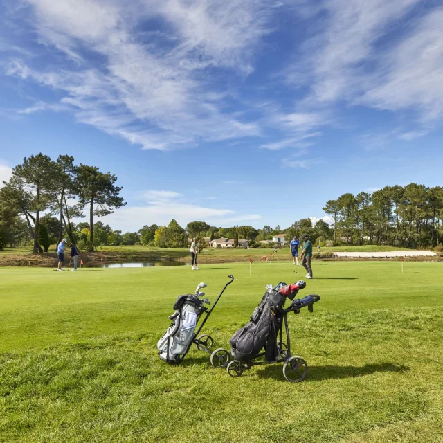 Caddie de golf en avant-plan et fairway derrière